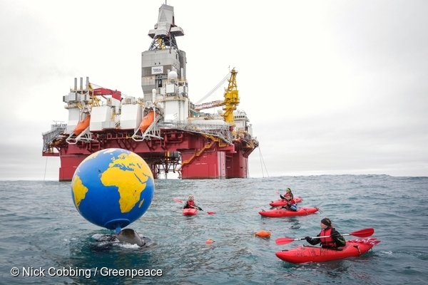 Greenpeace activists with the globe in front of the Songa Enabler