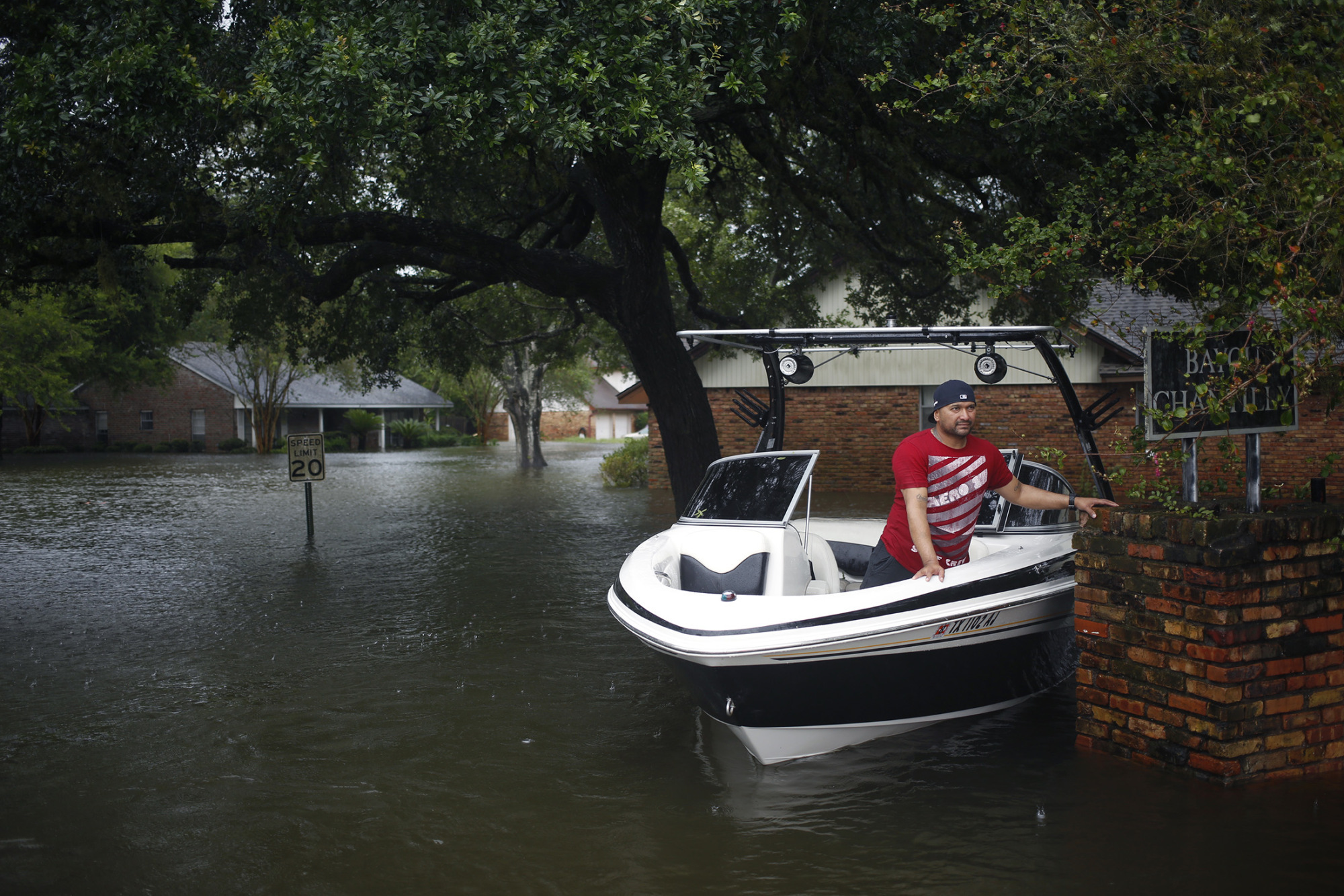 A man waits in a motorboat while making rescues in floodwaters from Hurricane Harvey in Dickinson, Texas, U.S., on Tuesday, Aug. 29, 2017. Estimates for damages caused by Hurricane Harvey are climbing with the storm poised to regain strength in the Gulf of Mexico before crashing back on land. Photographer: Luke Sharrett/Bloomberg