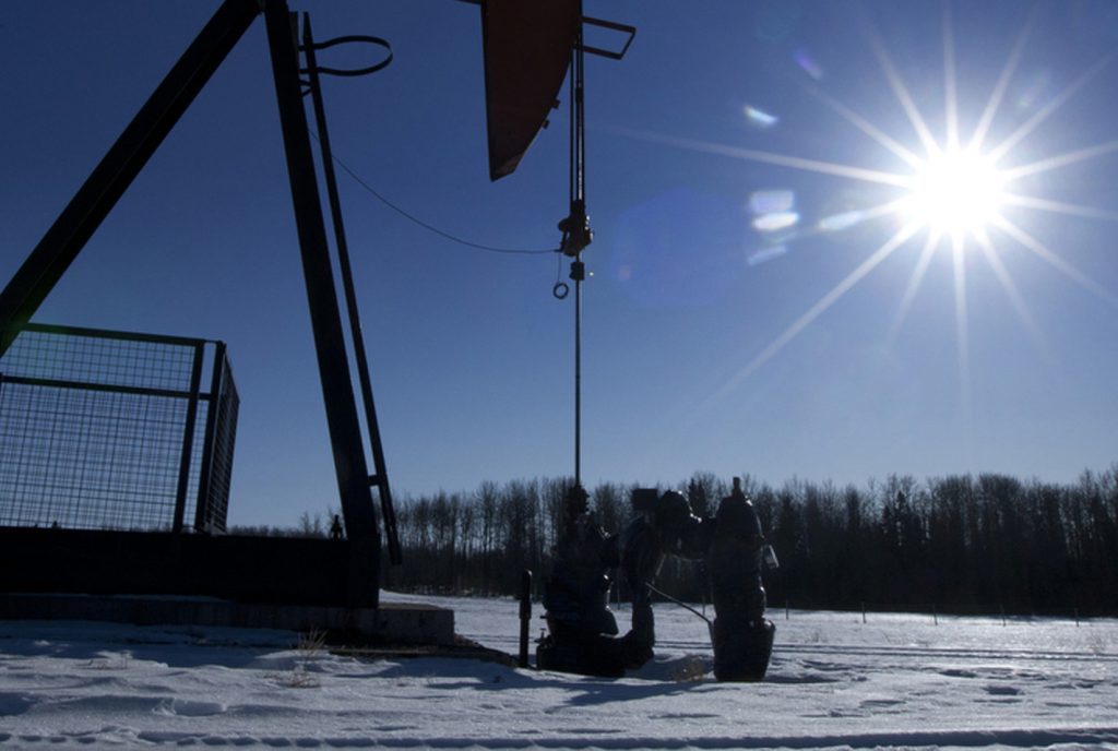 A pumpjack pumps oil from a well on a farmer's frozen field in a Pembina oil field near Pigeon Lake, Alberta, Canada on Friday, Feb. 17, 2012. The Pembina oil field is one of the largest oil fields in the province of Alberta. Photographer: Norm Betts/Bloomberg