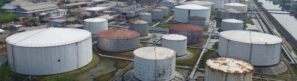 Fuel storage tanks stand at a PT Pertamina facility at Tanjung Priok Port in this aerial photograph taken in Jakarta, Indonesia, on Monday, Nov. 30, 2015. Indonesia will officially rejoin the Organization of Petroleum Exporting Countries (OPEC) when the cartel next meet on Dec. 4, seven years after it was suspended. Photographer: Dimas Ardian/Bloomberg