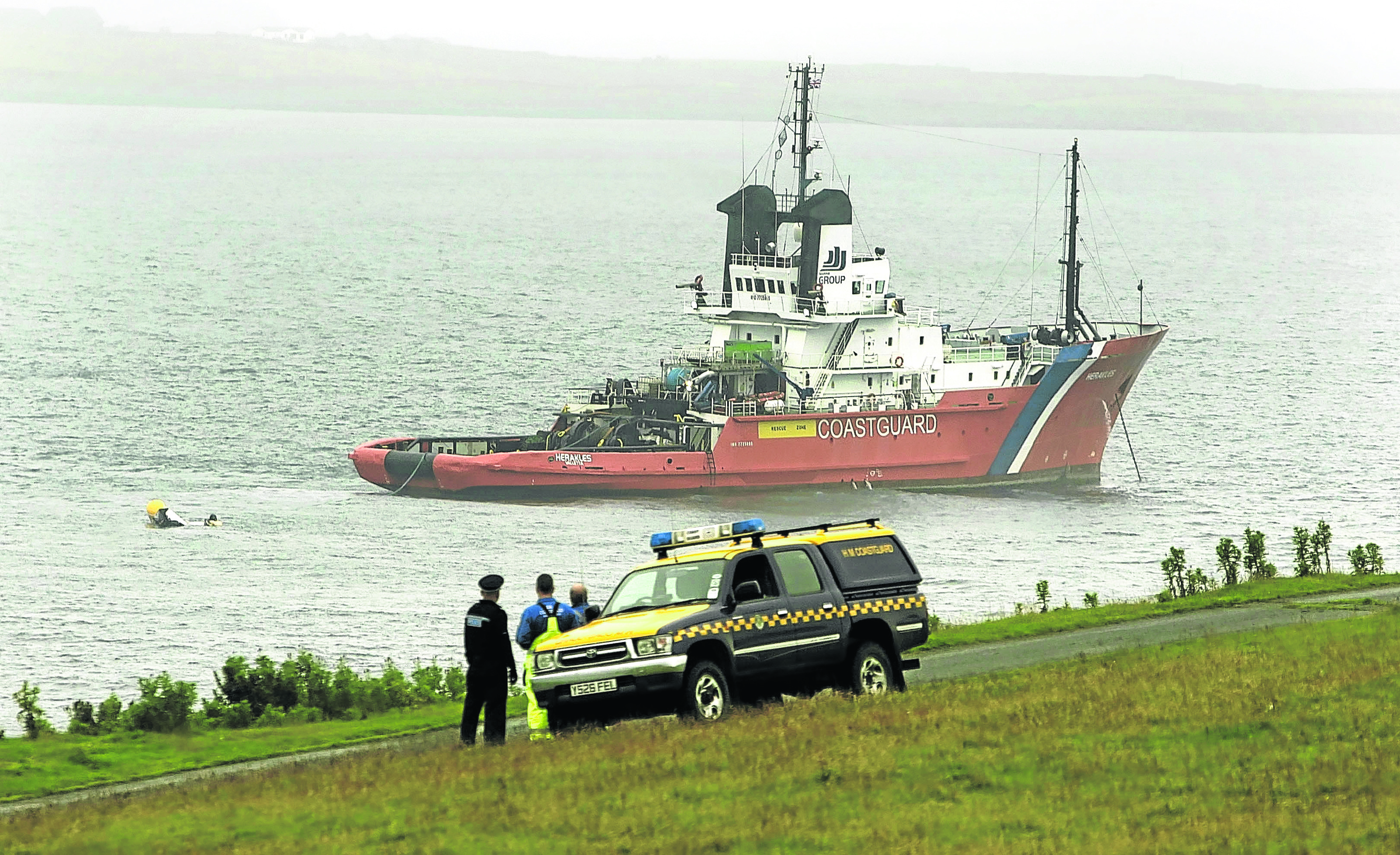 A Coastguard ship at Sumburgh works to recover the helicopter and bodies from the sea