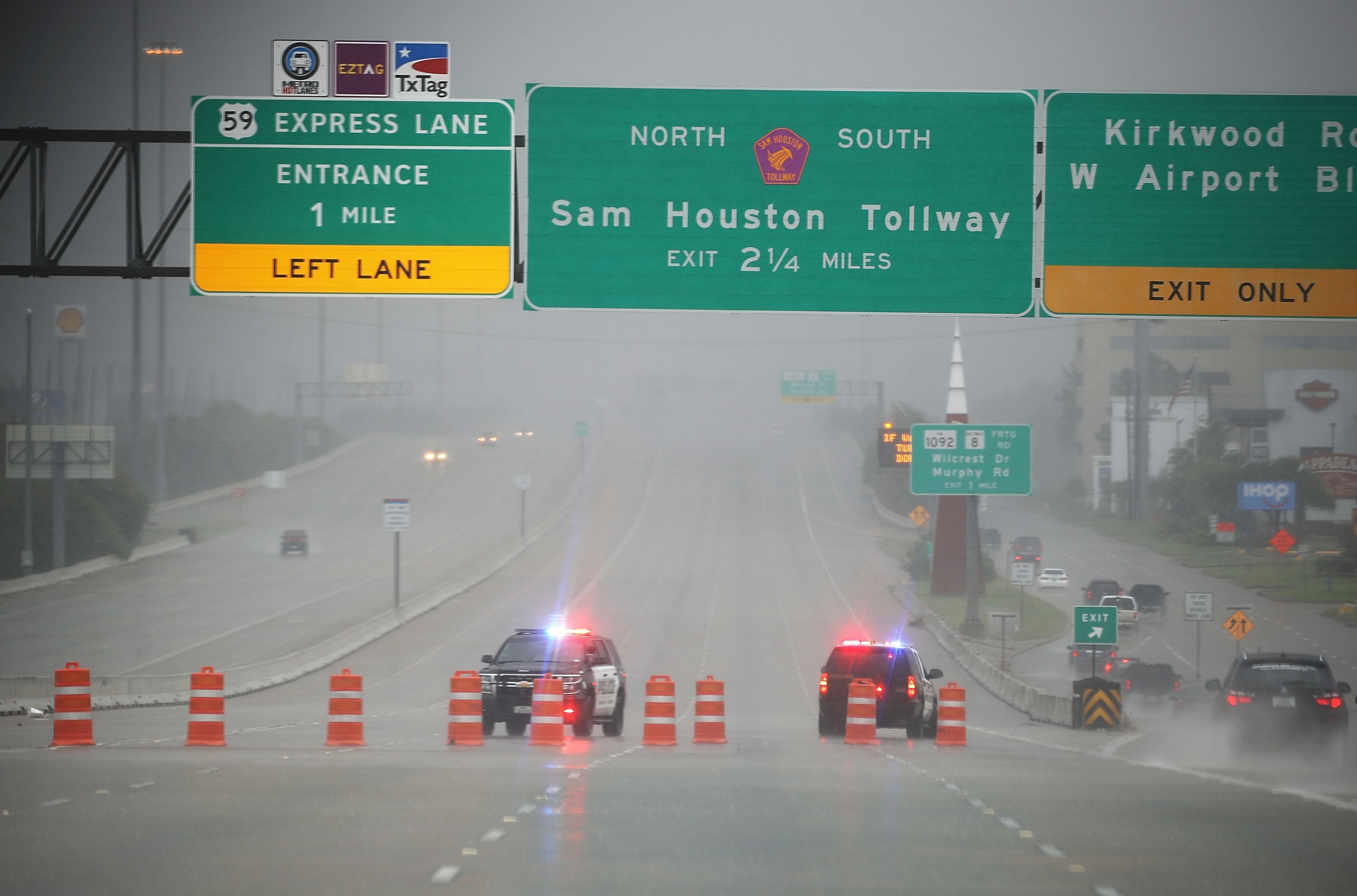 HOUSTON, TX - AUGUST 27:  Police shut down highway 69 due to flooding from Hurricane Harvey on August 27, 2017 in Houston, Texas. Harvey, which made landfall north of Corpus Christi late Friday evening, is expected to dump upwards to 40 inches of rain in Texas over the next couple of days.  (Photo by Joe Raedle/Getty Images)