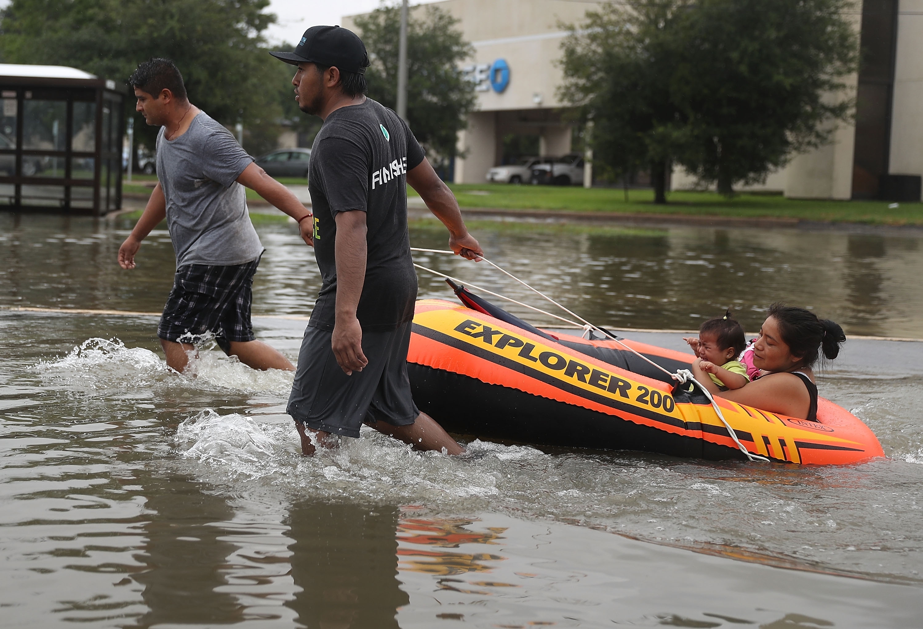 People use a boat to evacuate their home after the area was inundated with flooding from Hurricane Harvey