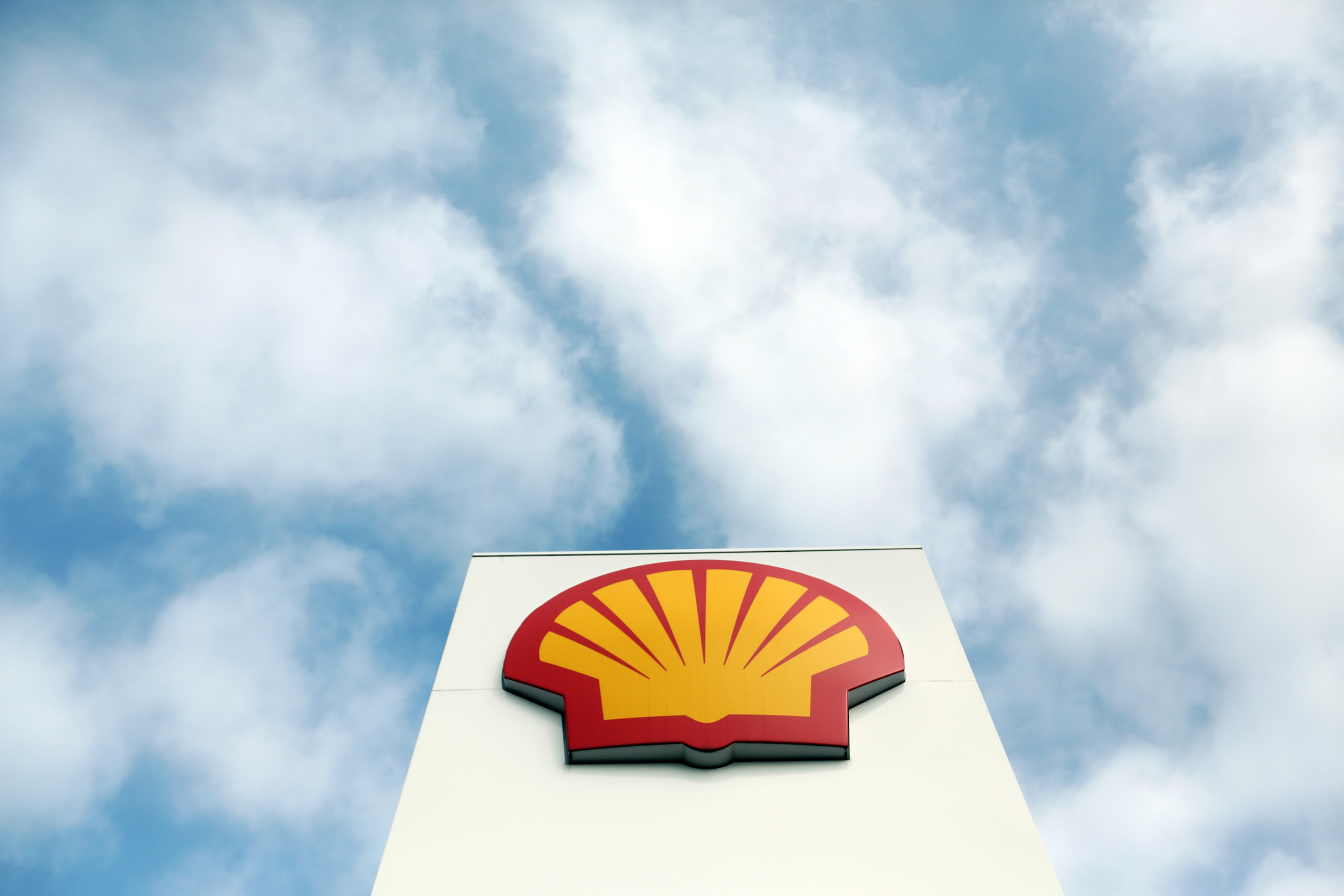 Shell logo against cloudy sky