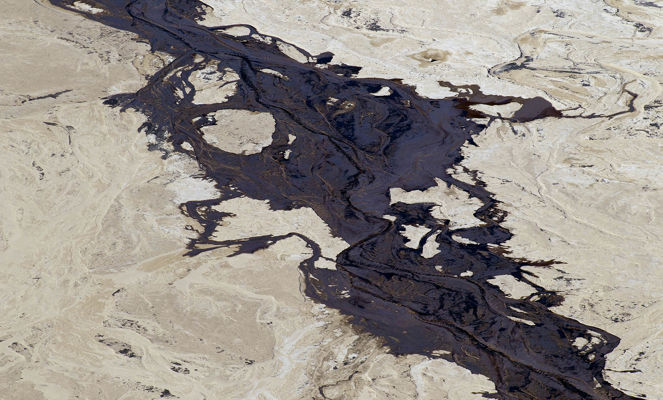 The Syncrude Canada Ltd. tailings pond stands in the Athabasca oil sands in this aerial photograph taken near Fort McMurray, Alberta, Canada. Photographer: Ben Nelms/Bloomberg