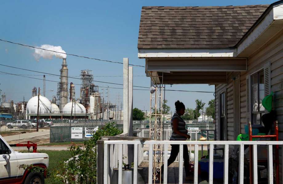 Griselda Silva walks into her sister's home along East Avenue P at Central St. across from the Valero Houston Refinery Thursday, May 15, 2014, in Houston.