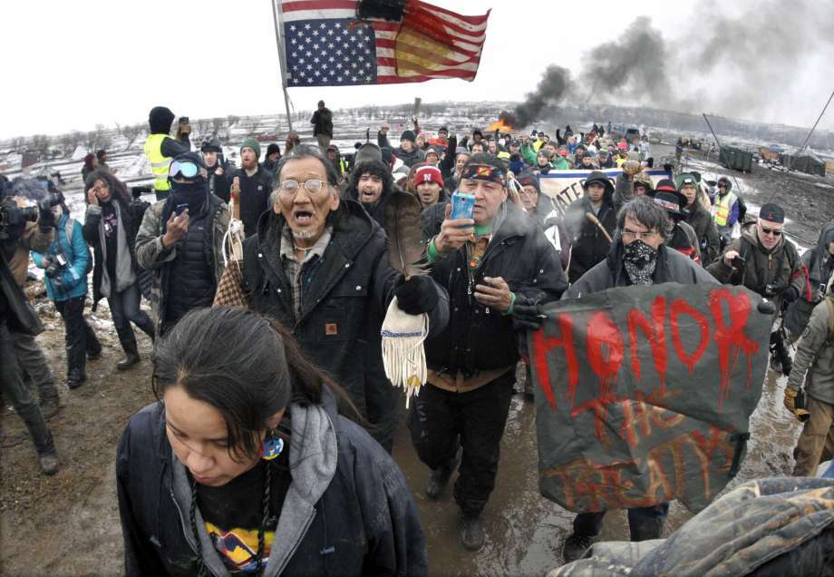 Dakota Access Pipeline protesters march out of their ﻿camp in February before the deadline set for evacuation ﻿by the U.S. Army Corps of Engineers. ﻿