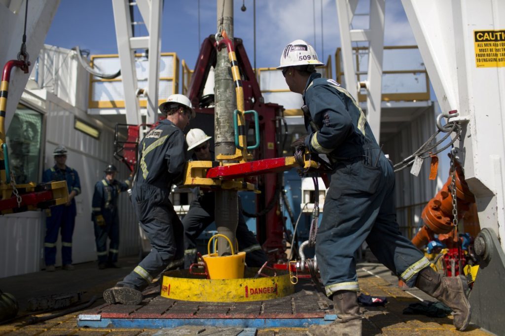 Employees torque a pipe at a wedge well at Christina Lake, a situ oil production facility half owned by Cenovus Energy Inc. and ConocoPhillips, in Conklin, Alberta, Canada, on Thursday, Aug. 15, 2013. Photographer: Brent Lewin/Bloomberg