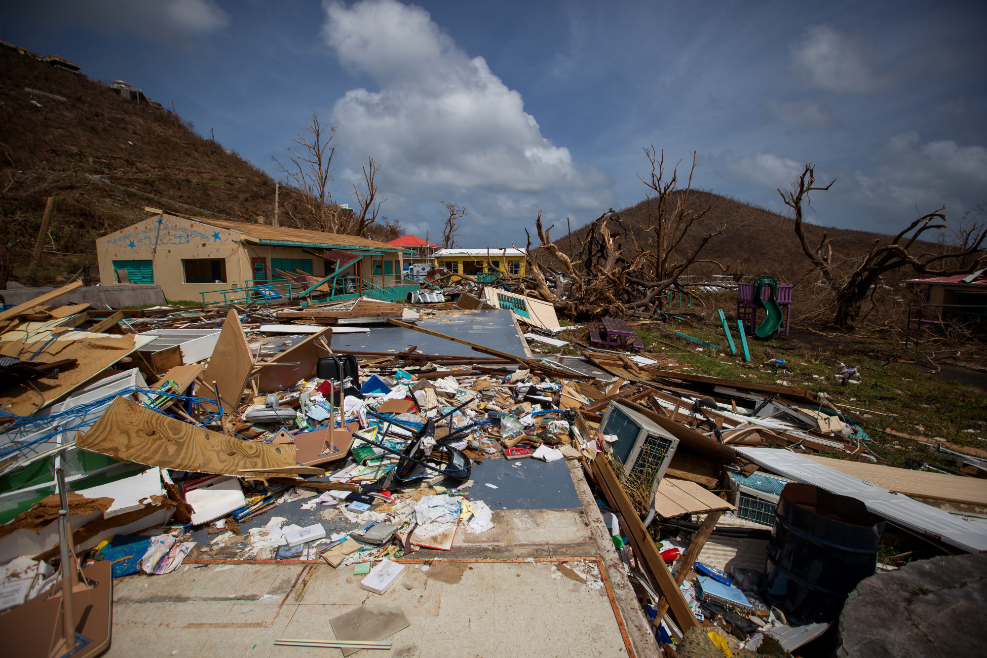 Debris sits in front of a damaged school after Hurricane Irma at Coral Bay in St John, U.S. Virgin Islands. Photographer: Michael Nagle/Bloomberg