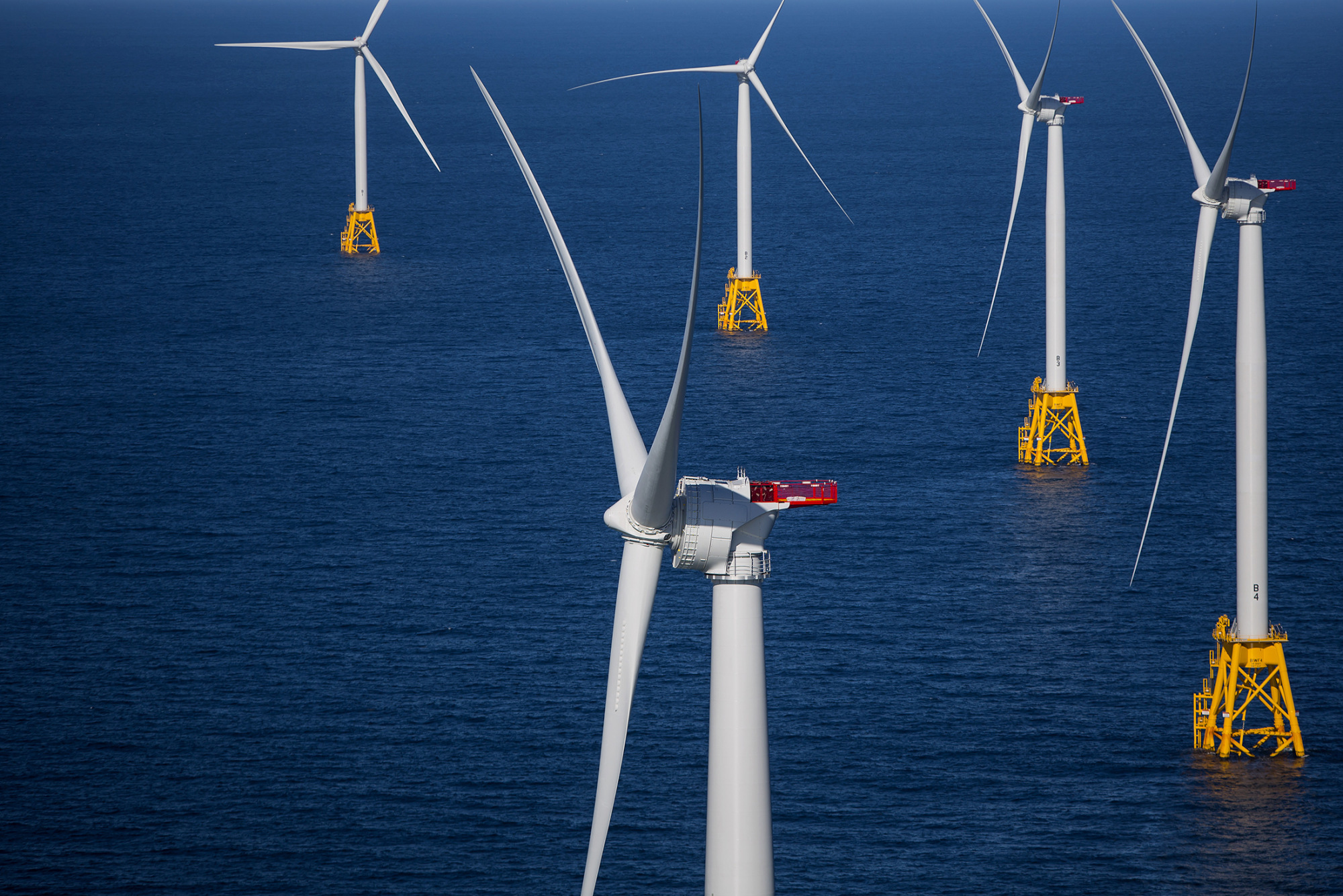 The GE-Alstom Block Island Wind Farm stands in this aerial photograph taken above the water off Block Island, Rhode Island, U.S., on Wednesday, Sept. 14, 2016. The installation of five 6-megawatt offshore-wind turbines at the Block Island project gives turbine supplier GE-Alstom first-mover advantage in the U.S. over its rivals Siemens and MHI-Vestas. Photographer: Eric Thayer/Bloomberg