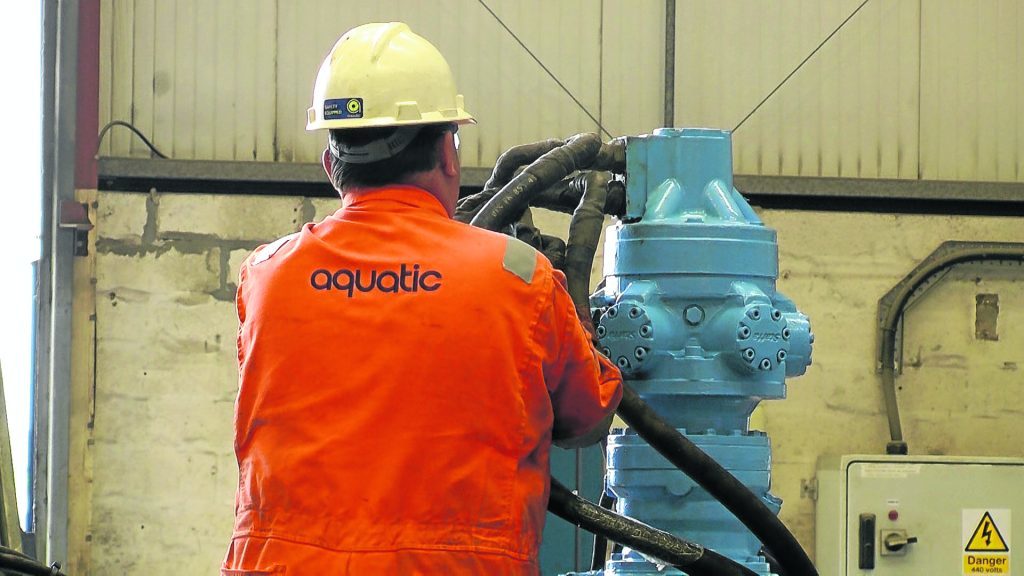 An employee of Aquatic, an Acteon company