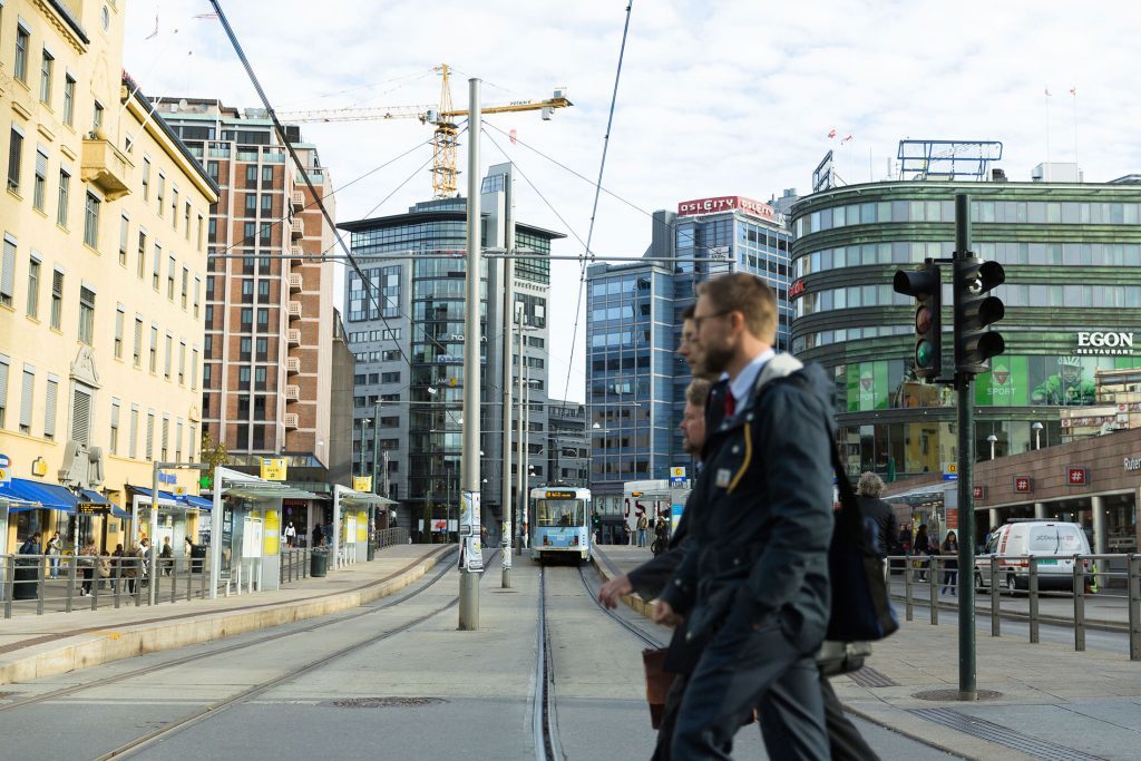 Pedestrians pass tramlines and commercial properties in the city center in Oslo, Norway, on Tuesday, Oct. 6, 2015. The nation could as soon as next year start making withdrawals from its massive $830 billion sovereign wealth fund, which it has built over the past two decades as a nest egg for "future generations." Photographer: Krister Soerboe/Bloomberg via Getty Images