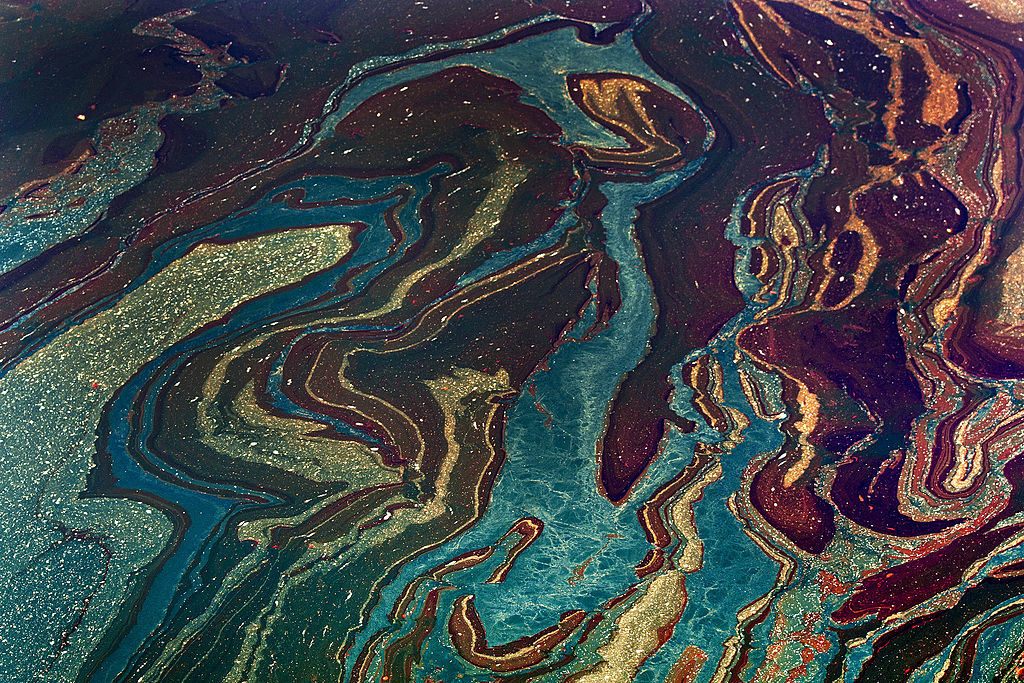 Oil floats in the Gulf of Mexico near Orange Beach, Alabama, U.S., on Friday, June 18, 2010. The BP Plc oil spill, which began when the leased Transocean Deepwater Horizon oil rig exploded on April 20, is gushing as much as 60,000 barrels of oil a day into the Gulf of Mexico, the government said. Photographer: Bloomberg/Bloomberg