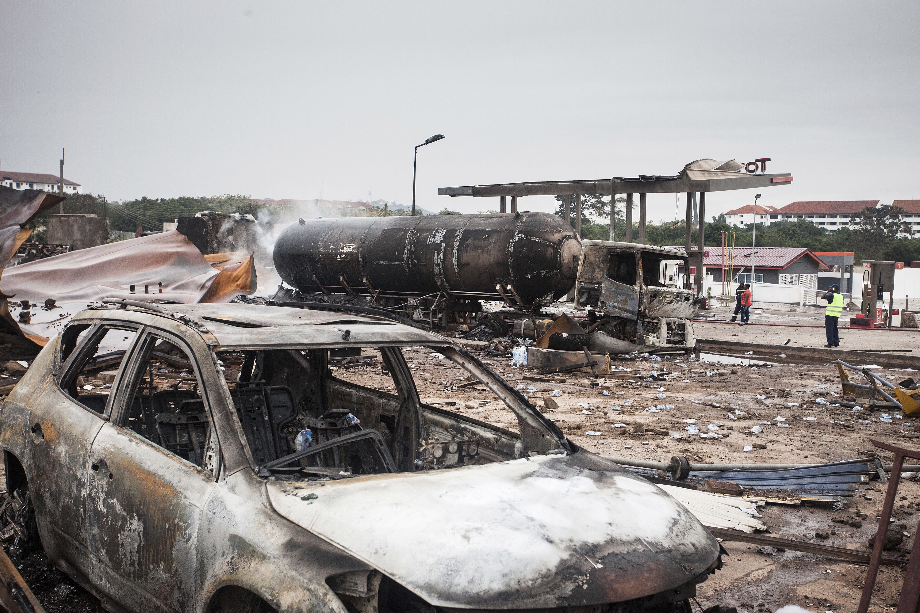 Firemen at the site of Saturday's gas tanker explosion in Accra, Ghana. Sunday Oct. 8, 2017.