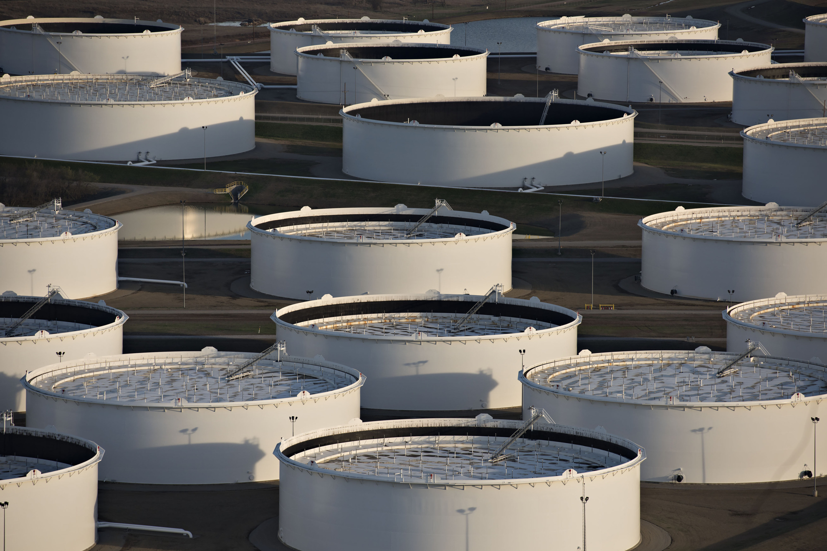 Oil storage tanks stand in this aerial photograph taken above Cushing, Oklahoma, U.S. Photographer: Daniel Acker/Bloomberg