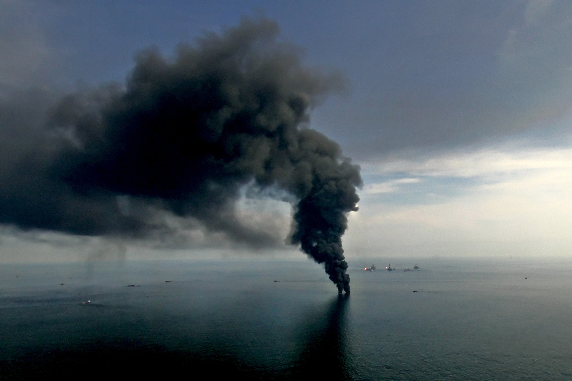 Smoke billows from controlled oil burns near the site of the BP Plc Deepwater Horizon oil spill in the Gulf of Mexico off the coast of Louisiana on June 19, 2010. Photographer: Derick E. Hingle/Bloomberg