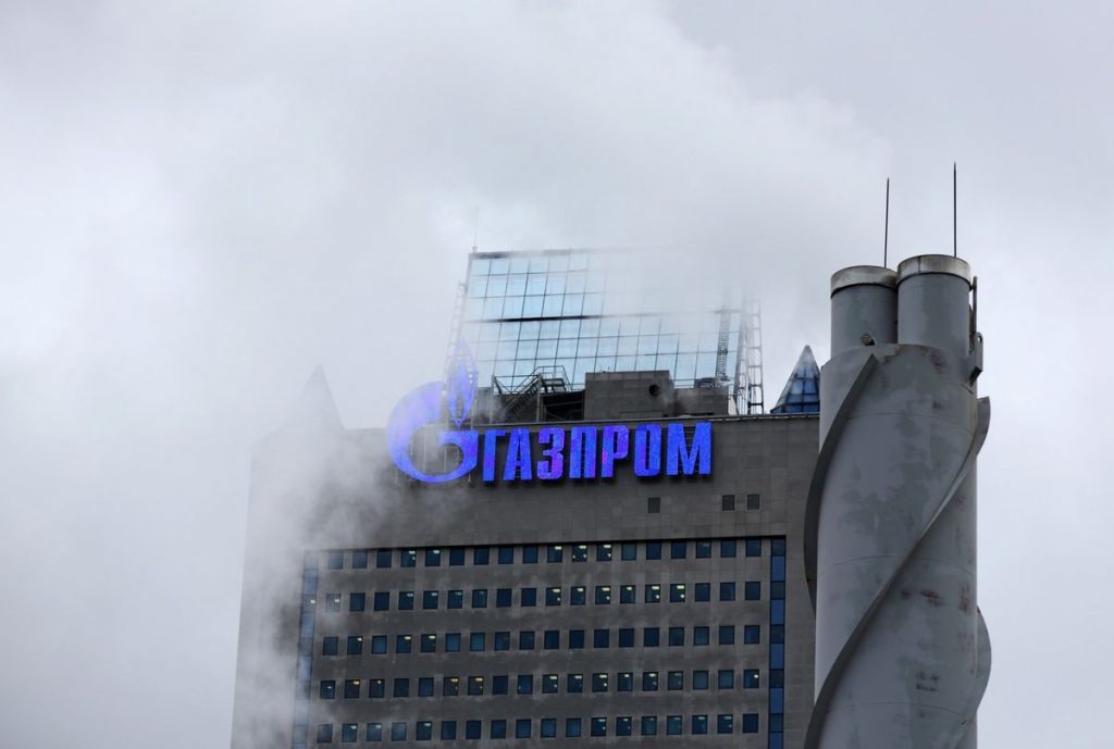 A logo sits on display outside the headquarters of OAO Gazprom in Moscow, Russia. Photographer: Andrey Rudakov/Bloomberg