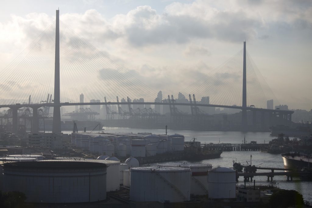 China Petroleum & Chemical Corp. (Sinopec) storage tanks, center, stand in the Tsing Yi area of Hong Kong, China, on Monday, Aug. 26, 2013. Photographer: Jerome Favre/