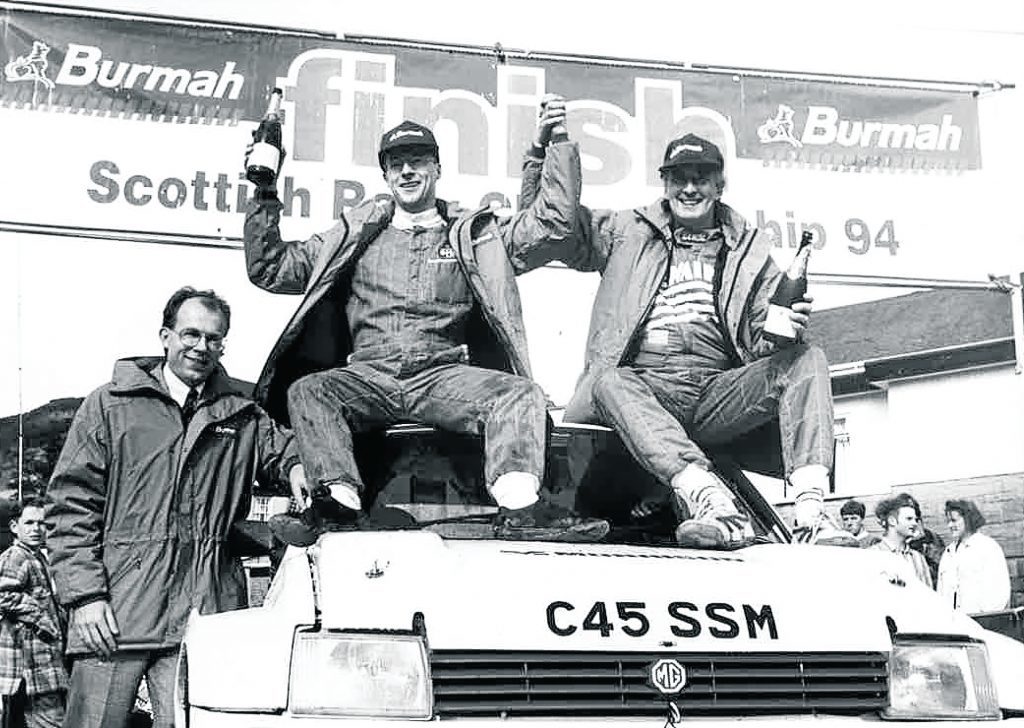 Donald Milne, middle, and Bob Wilson celebrate winning the championship with Richard Miles, of Burmah Petroleum, looking on