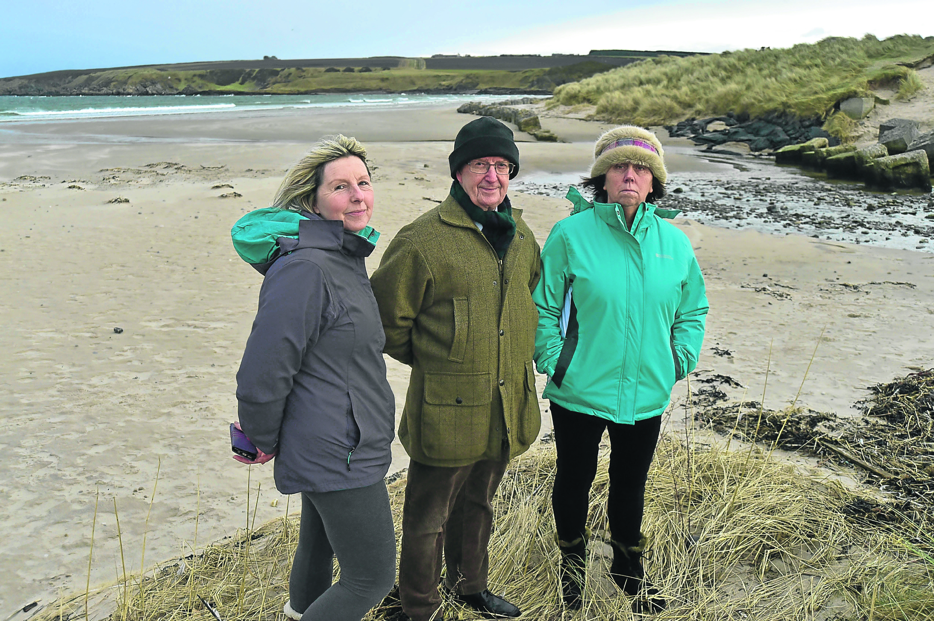 Sandend residents, from left, Tina Wilson, Ray Murray and Jane Winfield look over the area where the cables could come in