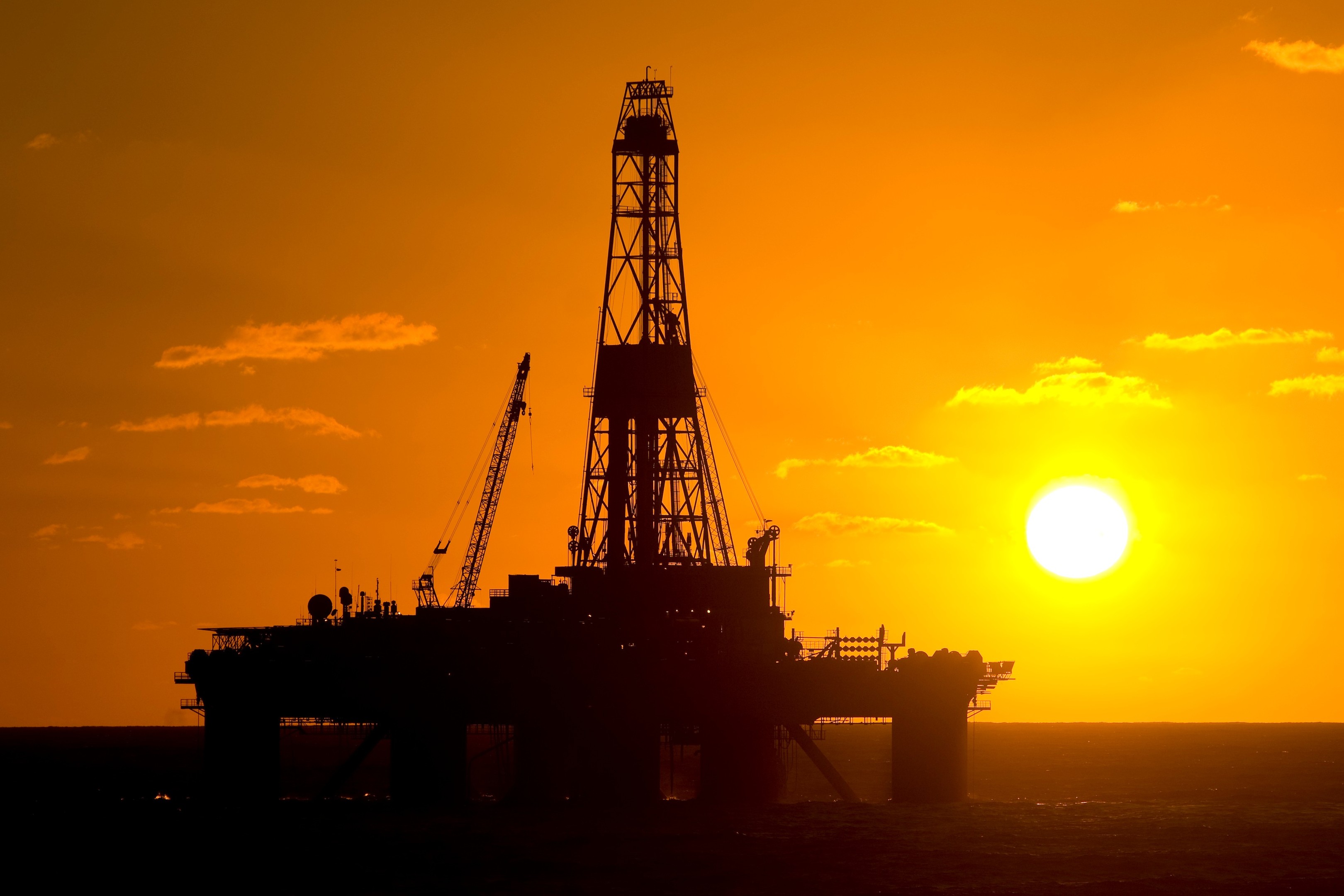 An oil rig at sunset