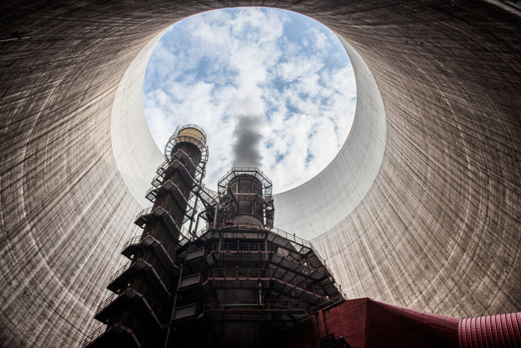 Steam rises from within a cooling tower at the Visonta coal power station, operated by Matrai Eromu Zrt, in Visonta, Hungary, on Wednesday, July 27, 2016. Coal for delivery in Europe in 2017 will fall about 11 percent by December, taking the gloss off the longest rally in year-ahead prices since 2010, according to a survey of traders and analysts by Bloomberg. Photographer: Akos Stiller/Bloomberg