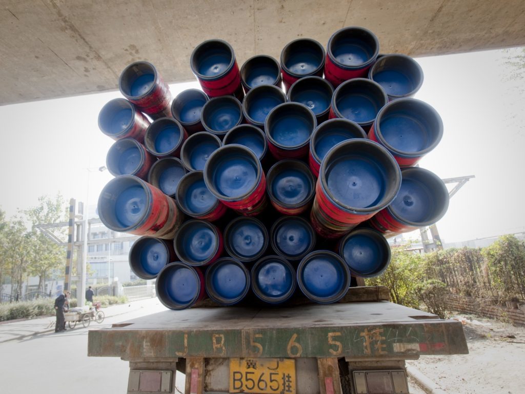 OCTG (oil country tubular goods) are loaded on a truck outside the Tianjin Pipe (Group) Corp. plant in Tianjin, China, on Tuesday, Nov. 2, 2010.  Photographer: Nelson Ching/Bloomberg
