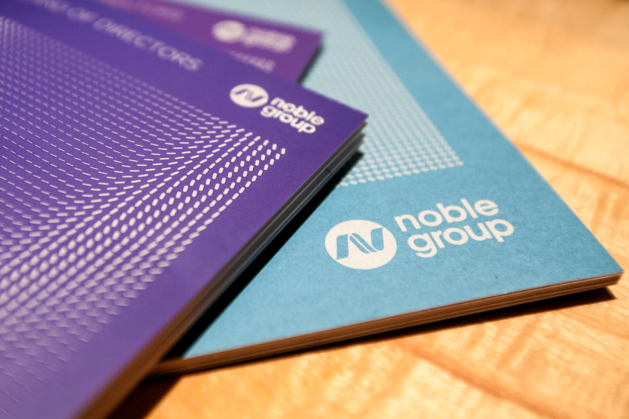 Noble Group Ltd. booklets sit on a table before a news conference during an investor day in Singapore, on Monday, Aug. 17, 2015. Noble GroupÂ Ltd. pledged to increase operating profit to more than $2 billion in the next three to five years as Asia's largest commodity trader sought to reassure investors about its long-term prospects. Photographer: Nicky Loh/Bloomberg