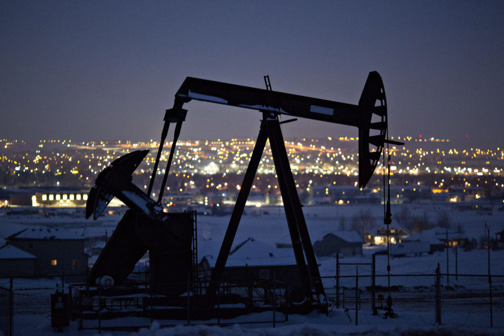 A pumpjack operates above an oil well at night in the Bakken Formation on the outskirts of Williston, North Dakota, U.S., on Thursday, March 8, 2018. Photographer: Daniel Acker/Bloomberg