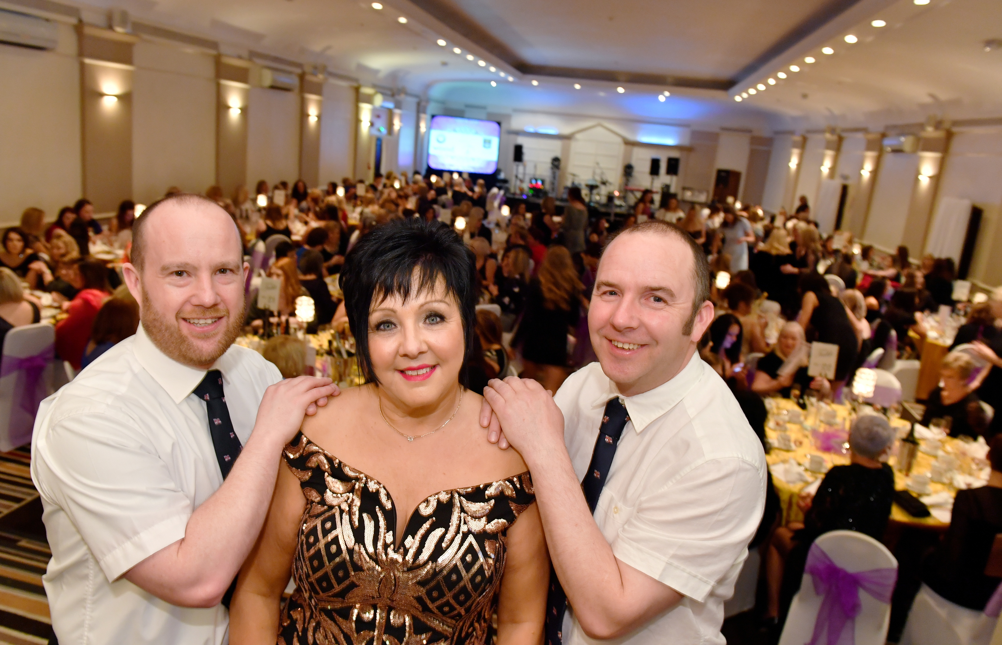 Audrey Wood who with her annual Ladies Glamour Glitz and Bubbles afternoon has raised £162,000 to date for the RNLI.   
Audrey is pictured with RNLI crew members Deputy Coxwain Robbie Coull (left) and ILB Helm Bruce Finnie at her latest event at the Douglas Hotel.    
Picture by Kami Thomson    03-03-18