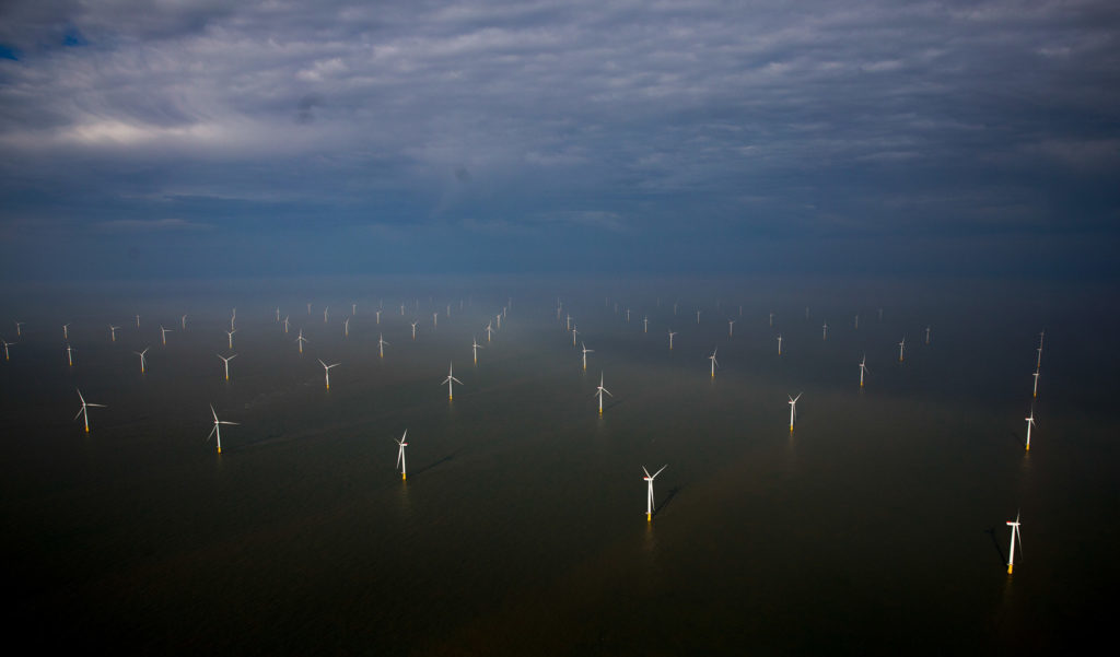 Wind turbines sit in the North Sea at the London Array offshore wind farm, a partnership between Dong Energy A/S, E.ON AG and Abu Dhabi-based Masdar, in the Thames Estuary, U.K. Photographer: Simon Dawson/Bloomberg