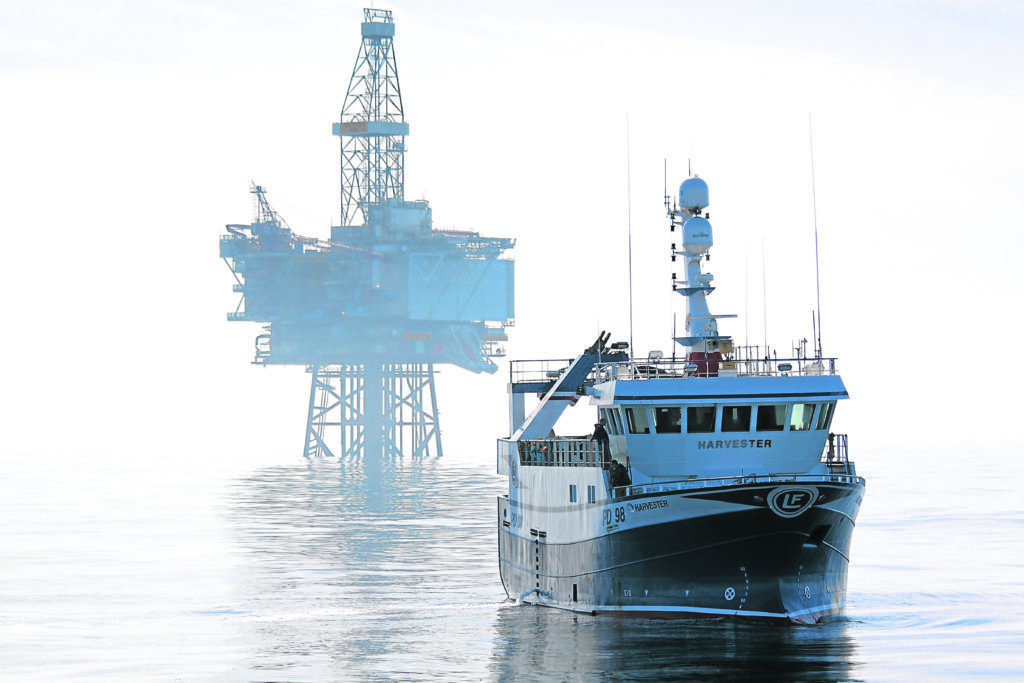 E45R11 Fishing vessel Harvester and the Jotun B oil production platform. North Sea May 2010