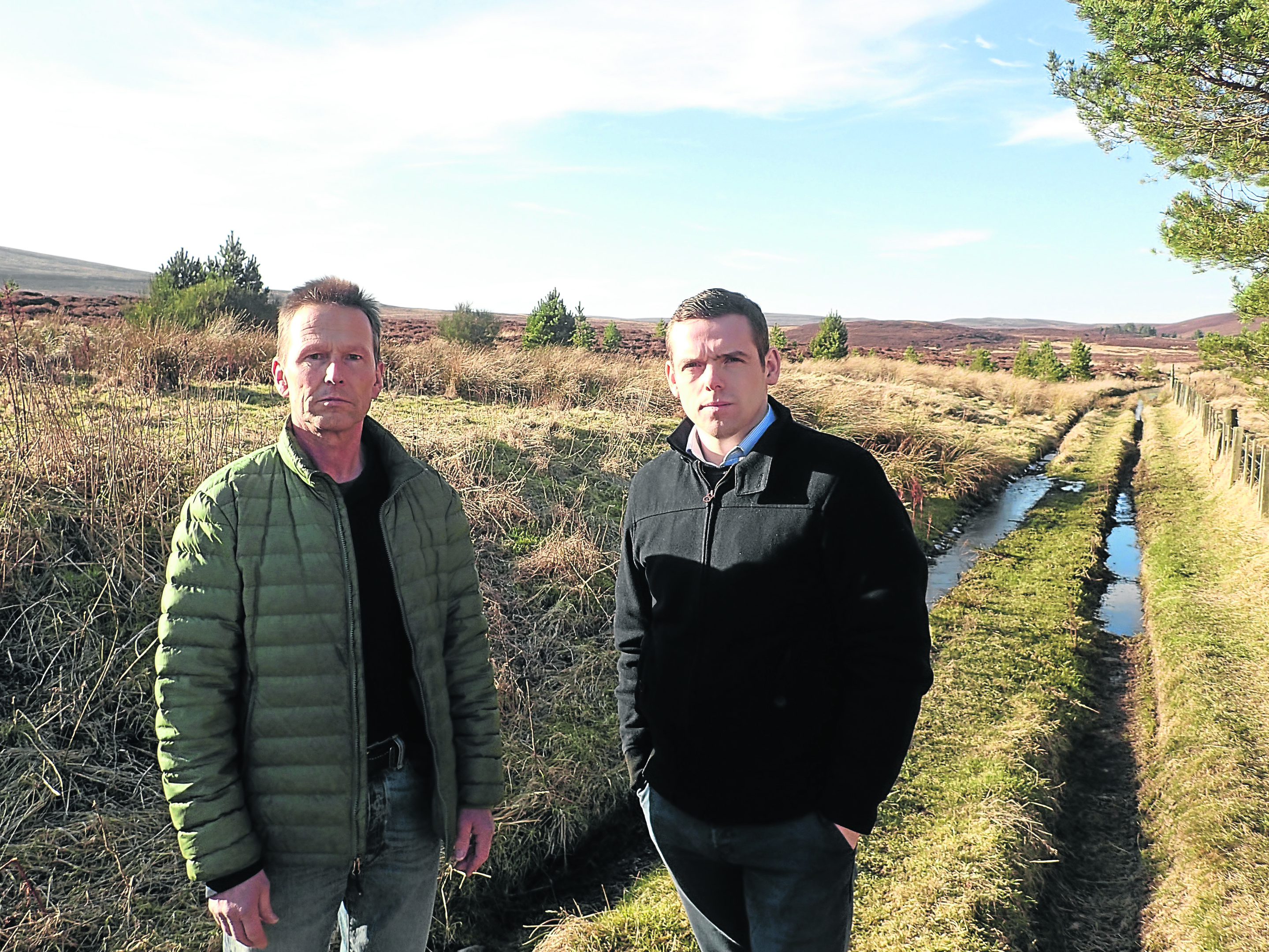 Moray MP Douglas Ross, right, at Knockando windfarm site with local businessman Joerg Bondzio who fears for his livelihood