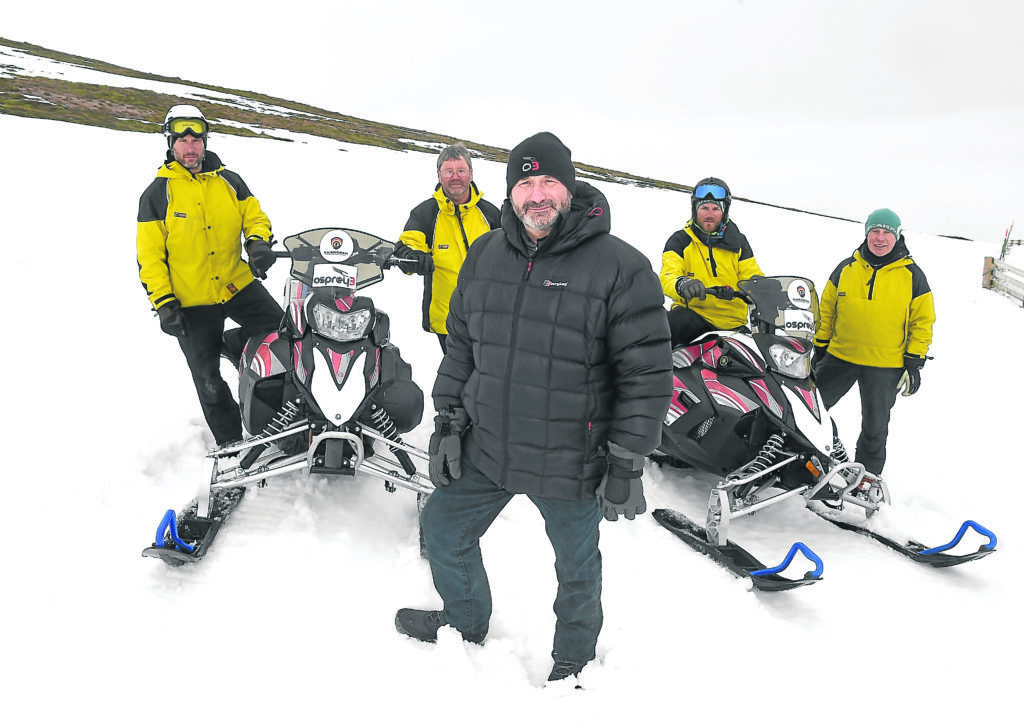 The Cairngorm Mountain Rescue Team have been presented with two new snow scooters by Andy Clark and Laura Hepburn of Kintore based oil and gas filtration company, Osprey3 on Cairngorm on Friday.  Andy Clark in the foreground with team members Brian Fishpool, Willie Anderson, Iain Cornfoot and Willie Ross.