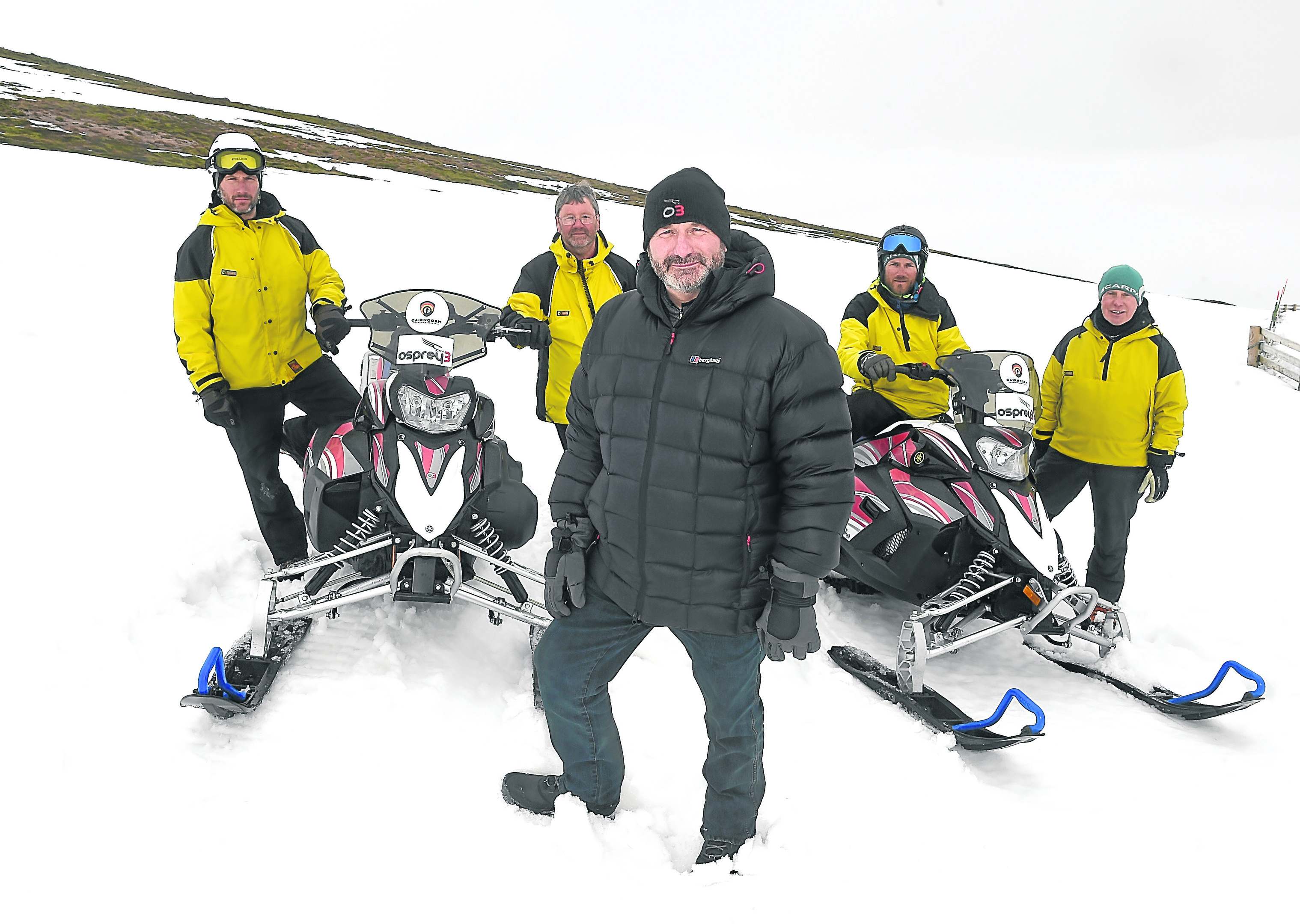 The Cairngorm Mountain Rescue Team have been presented with two new snow scooters by Andy Clark and Laura Hepburn of Kintore based oil and gas filtration company, Osprey3 on Cairngorm on Friday.  Andy Clark in the foreground with team members Brian Fishpool, Willie Anderson, Iain Cornfoot and Willie Ross.
