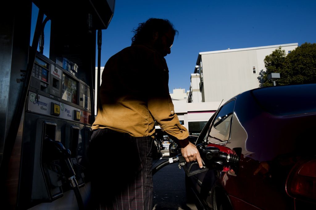 A customer fills a vehicle with gasoline at a Chevron Corp. station in San Francisco, California, U.S. Photographer: David Paul Morris/Bloomberg