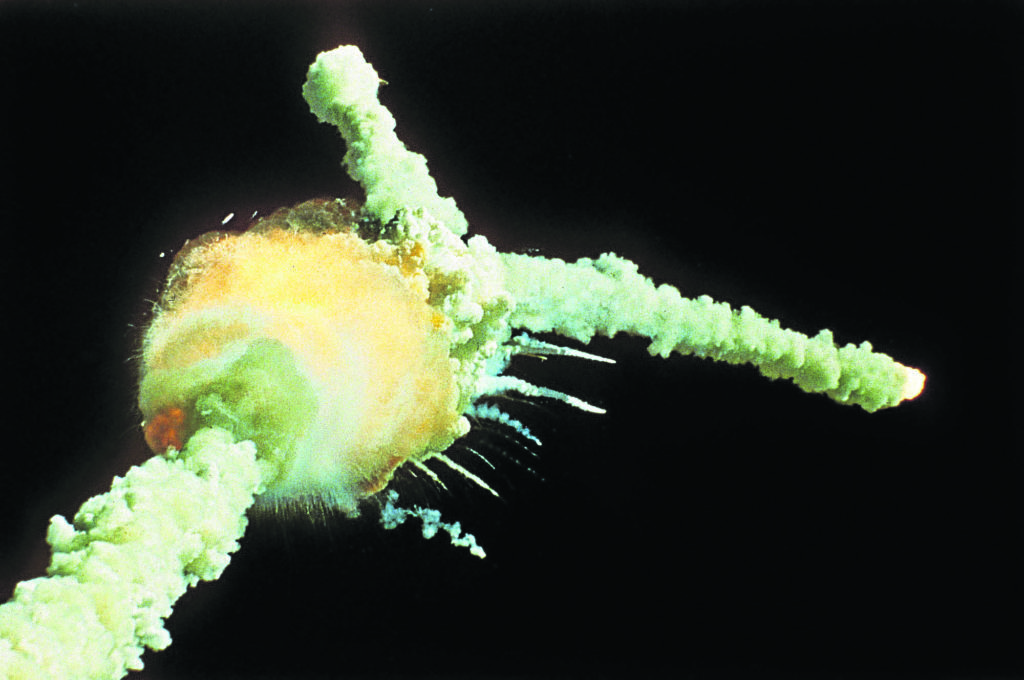 The space shuttle Challenger explodes shortly after lifting off.
