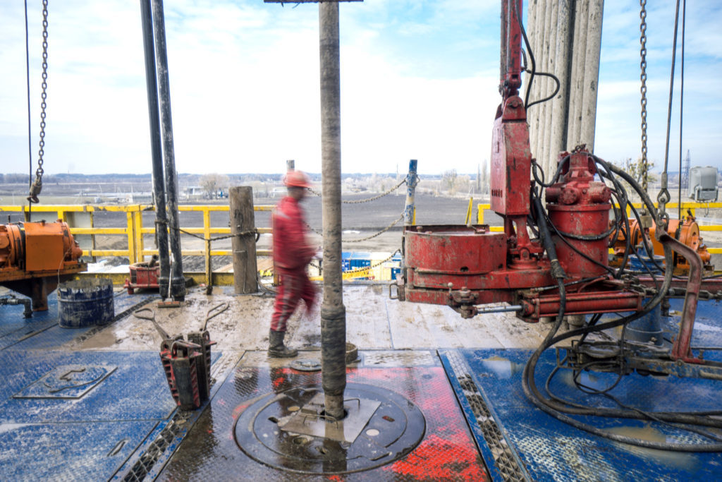 A Chinese worker from XinJiang Beiken Energy Engineering Stock Co. Ltd. walks past the turntable and drill pipe during gas drilling operations for the Ukrgazvydobuvannya Subsidiary Co. of Naftogaz of Ukraine National JSC in Poltava region, Ukraine, on Wednesday, April 4, 2018. Ukraine transports about one third of Russias natural gas supplies to the European Union through a pipeline network connected with Slovakia, Romania, Hungary, Poland and Moldova. Photographer: Vincent Mundy/Bloomberg