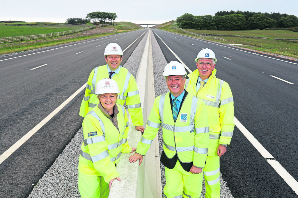 ALL smiles: Aberdeen City Council co-leaders Jenny Laing and Douglas Lumsden with Economy Secretary Keith Brown, and Aberdeenshire Council leader, Jim Gifford, on the first main stretch of the AWPR to open