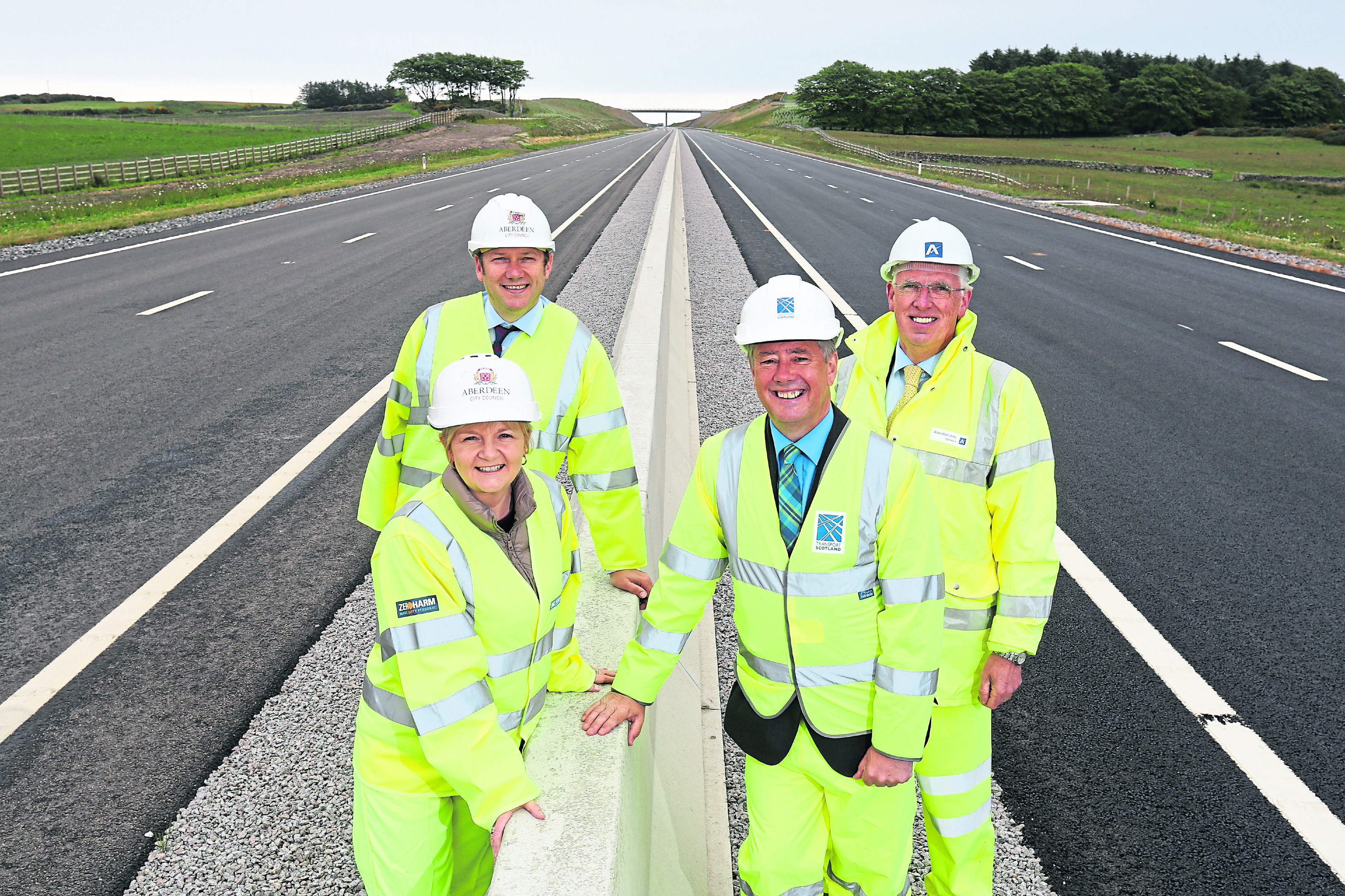 ALL smiles: Aberdeen City Council co-leaders Jenny Laing and Douglas Lumsden with Economy Secretary Keith Brown, and Aberdeenshire Council leader, Jim Gifford, on the first main stretch of the AWPR to open