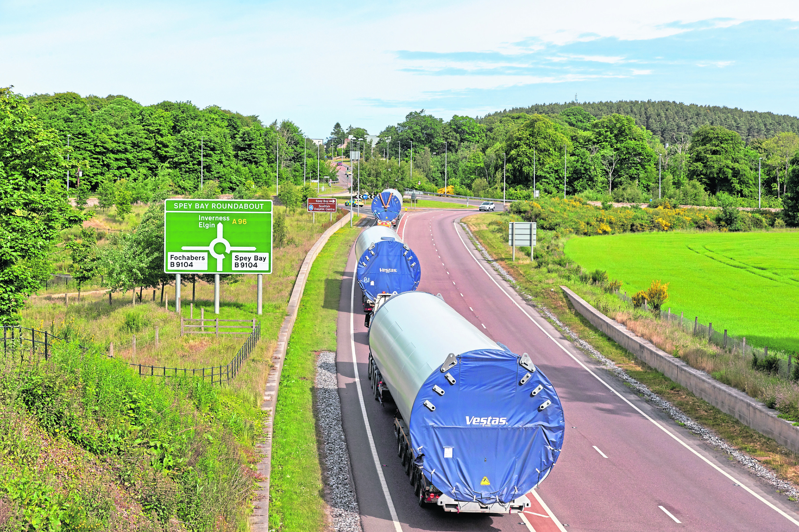 return journey: Three turbine base units slow traffic down as they make their way along the A96 at Fochabers Bypass
