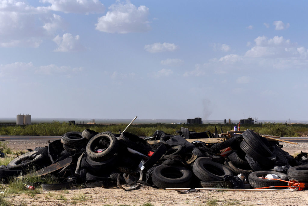 A pile of tires sits off of Route 285 near Pecos, Texas, on July 18. Photographer: Callaghan O'Hare/Bloomberg