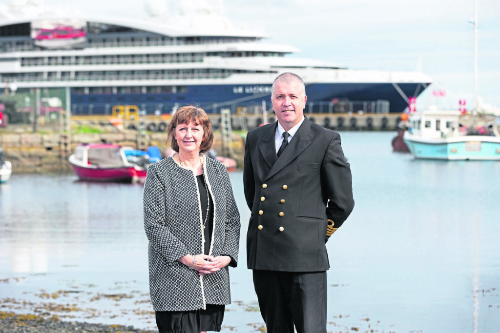 Lerwick Port Authority’s Sandra Laurenson,   and her successor-designate as Chief Executive, Captain Calum Grains, with the cruise ship, Le Laperouse, in the background