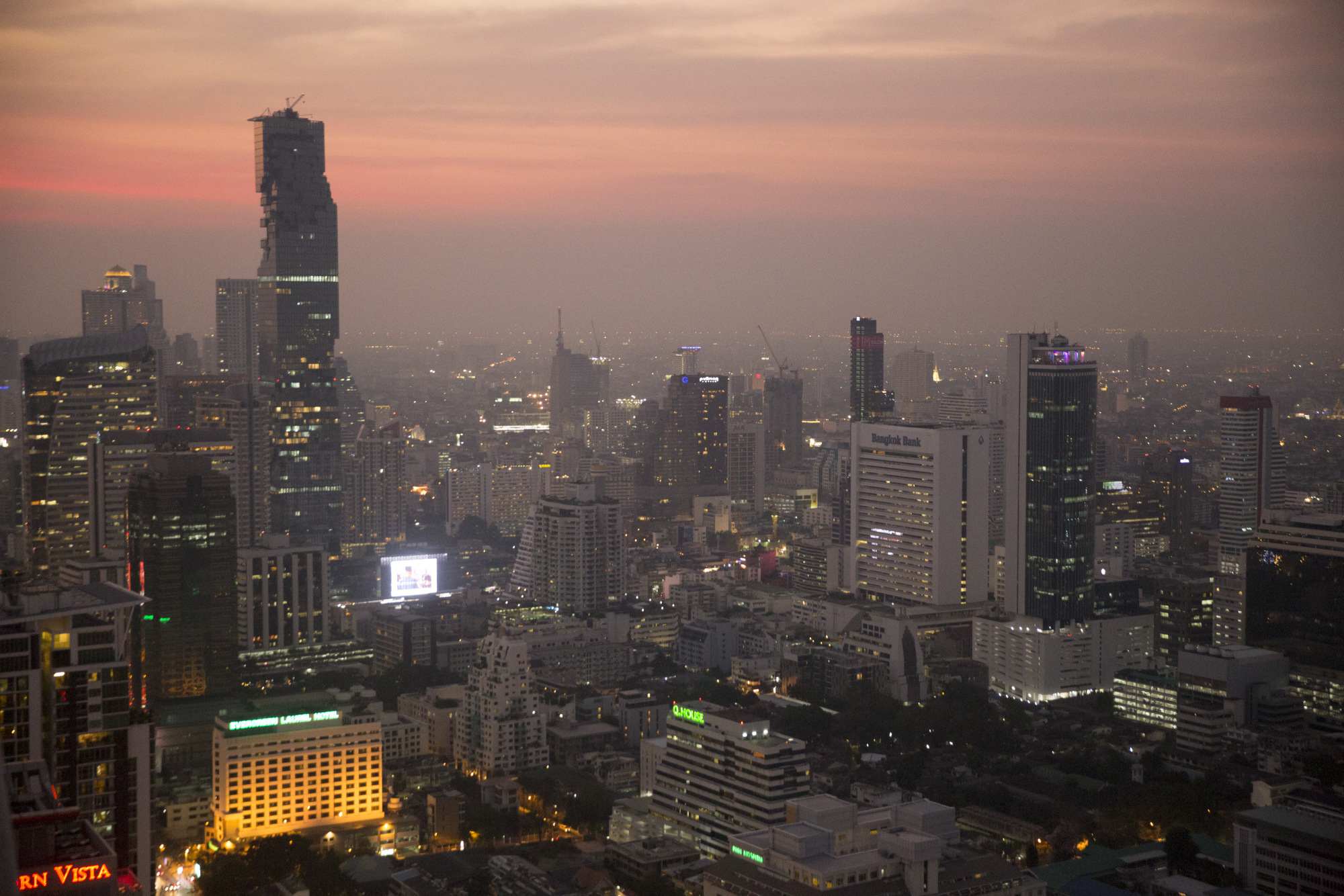 Buildings stand illuminated at dusk in the Sathorn district of Bangkok, Thailand, on Monday, Jan. 30, 2017. Thailand's central bank held its key interest rate near a record low to shield the nation's economic recovery as the threat of trade protectionism mounts. Photographer: Brent Lewin/Bloomberg
