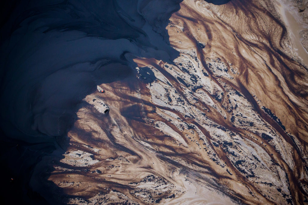 The Suncor Energy Inc. Steepbank mine is seen in this aerial photograph taken above the Athabasca oil sands near Fort McMurray, Alberta, Canada, on Monday, Sept. 10, 2018. While the upfront spending on a mine tends to be costlier than developing more common oil-sands wells, their decades-long lifespans can make them lucrative in the future for companies willing to wait. Photographer: Ben Nelms/Bloomberg