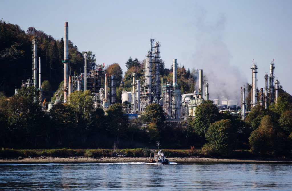 A boat sails past the Burnaby Refinery, operated by Parkland Fuel Corp., in Burnaby, British Columbia, Canada, on Wednesday, Sept. 19, 2018.