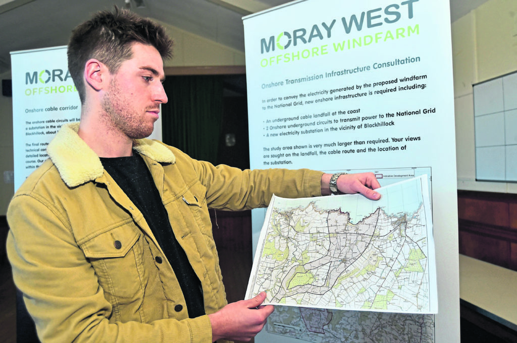 Sandend resident Johnny Ewart examines Moray West Offshore Windfarm plans at a community consultation meeting.