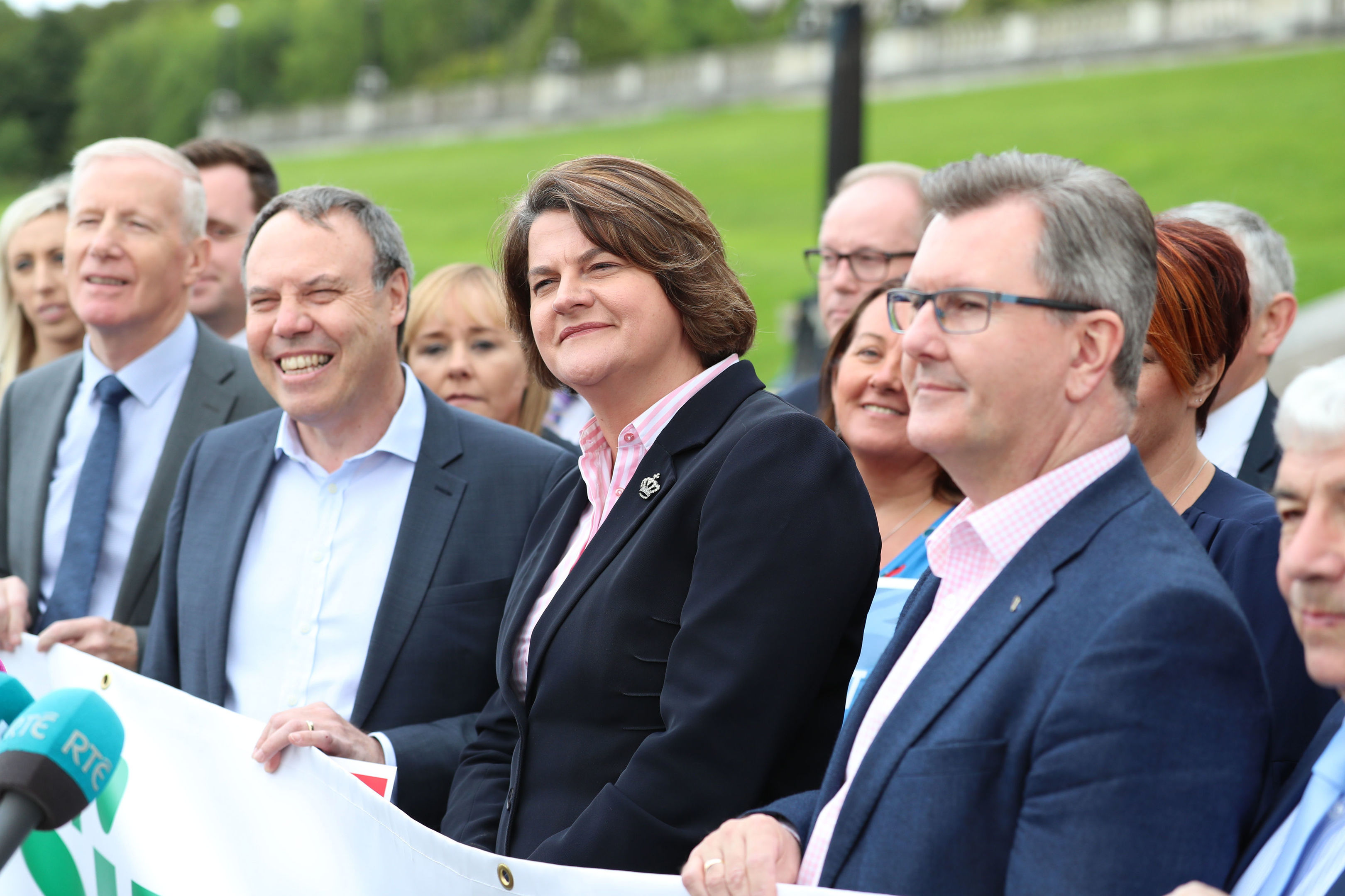 DUP leader Arlene Foster unveils a banner with party colleagues outside Parliament Buildings at Stormont in Belfast: Liam McBurney/PA Wire