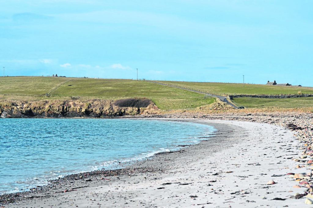 Sand of Wright beach and the road to Hoxa with a normal power line of single poles