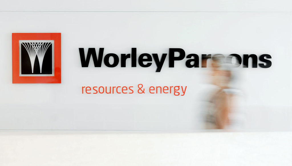 An employee walks through the reception area in the headquarters of WorleyParsons Ltd., in Sydney, Australia. Photographer: JACK ATLEY/Bloomberg